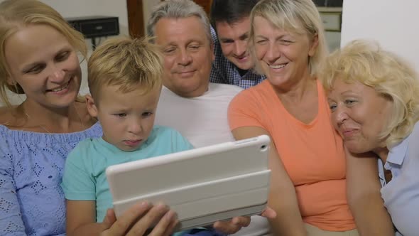 Big family watching video on touch pad