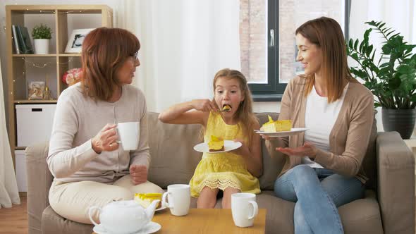 Mother, Daughter and Grandmother Eating Cake