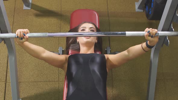 Pretty Active Fit Woman Training Hard in Underground Garage Using Iron Barbell