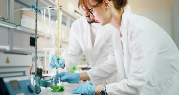 Young Students of Chemistry Working in Laboratory