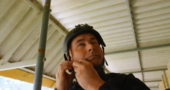 Low angle view of mid-adult caucasian military soldier wearing combat helmet during military trainin