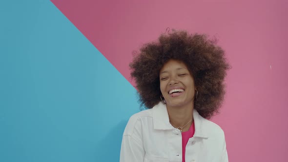 Beautiful young woman with curly hairstyle and fashionable clothes