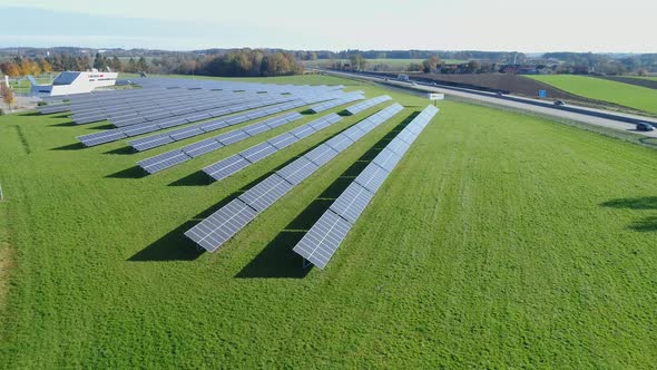 Aerial multishot of solarfarm with highway traffic