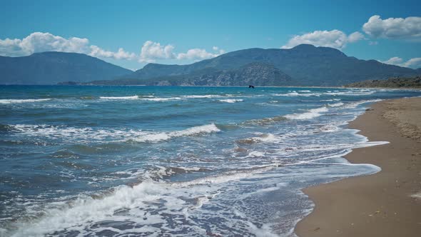 Waving Sea with Waves at Sunny Summer Windy Day at Beautiful Sandy Empty Beach Iztuzu in Turkey