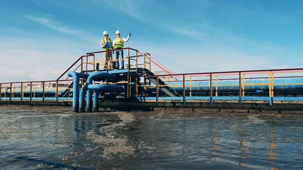 Two Engineers Are Observing the Sewage Treatment Site