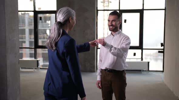 Happy Man Buyer Getting Keys To Bought Apartment