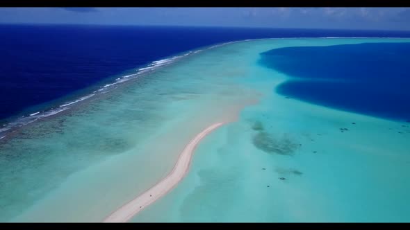 Aerial top down sky of idyllic bay beach break by blue water and white sandy background of a dayout 