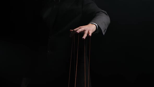 Puppet Master Controls and Manipulates the Puppets with Strings Attached To His Fingers