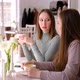 Two young women in cafe drinking coffee and chatting - VideoHive Item for Sale