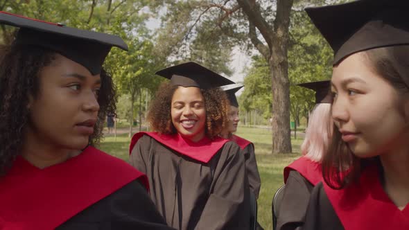 Portrait of Smiling Lovely Black Female Student in Academic Dress at Graduation Ceremony