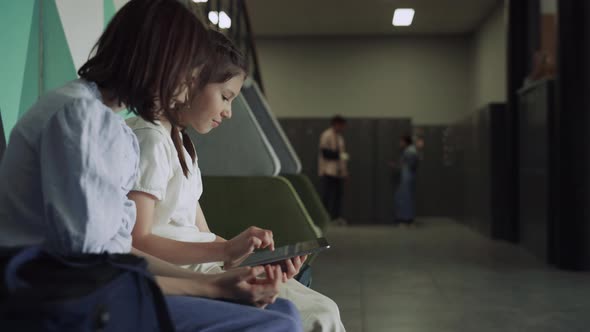 Smiling Schoolgirls Using Tablet at School Break