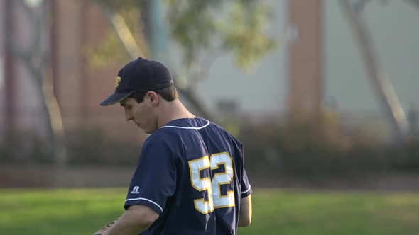 A young man playing catch with a baseball.