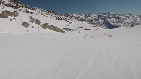 Ski Slope With Other Skiers In View And Mountains