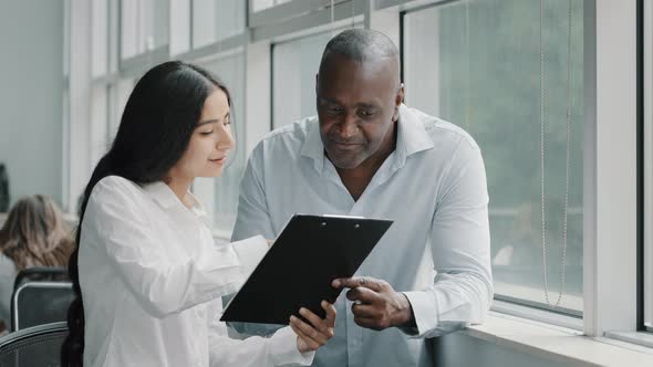 Diverse African and Arabian Colleagues Multiracial People Business Partners Stand Near Window