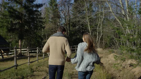 Couple holding hands and running