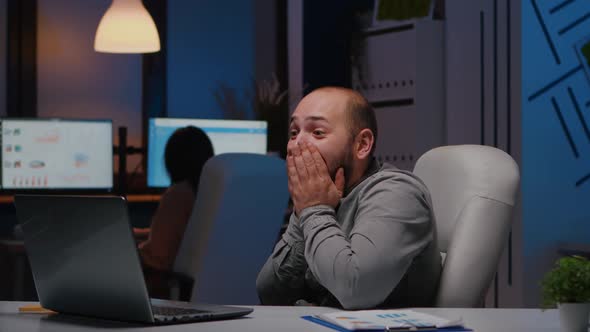 Happy Cheerful Businessman Smiling While Looking at Laptop Computer Display