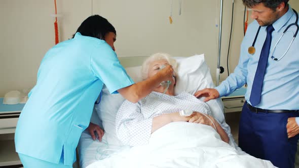 Female doctor putting oxygen mask on patient