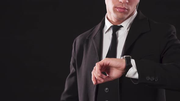 The Young James Bond Checks His Wristwatch