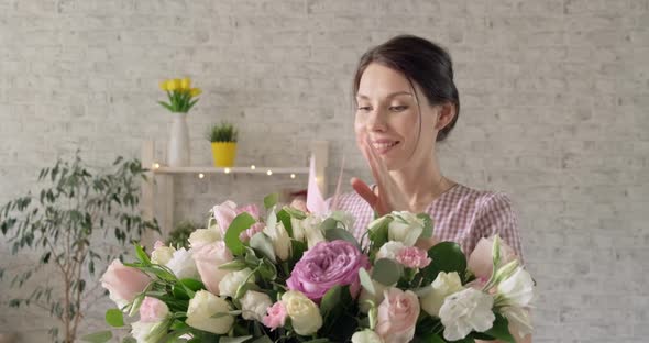 Young Girl with Closed Eyes Receives Bouquet of Flowers