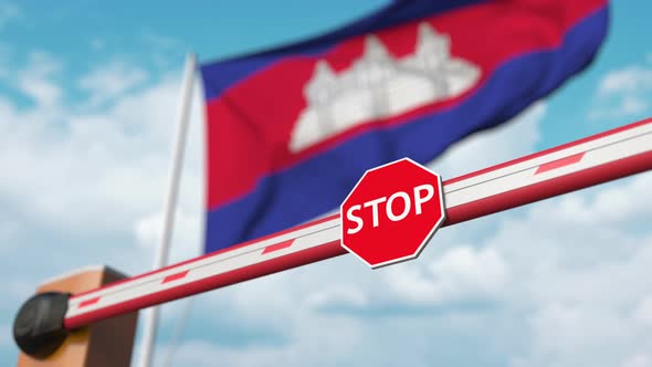 Opening Boom Barrier and Stop Sign Against the Cambodian Flag