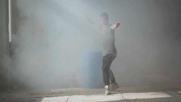 Professional Young Passionate Hip-hop Dancer Performing in the Fog