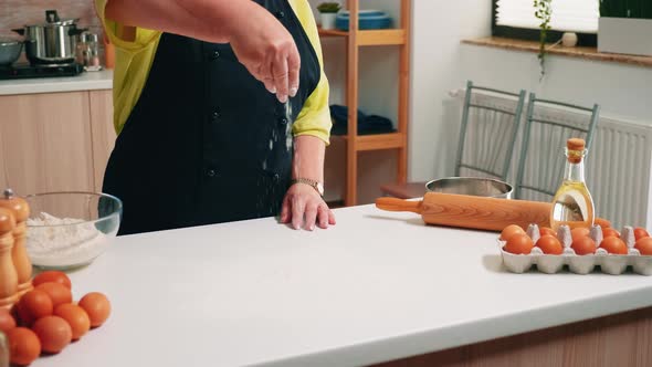 Close Up of Hand Sieving Flour