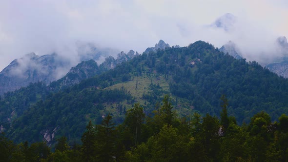 Time lapse with mountains, forest and fog