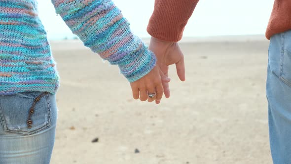 Close up of adult man and woman holding hands with love and romance relationship