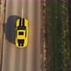An Aerial View of a Driving Yellow Car with Two Black Stripes - VideoHive Item for Sale
