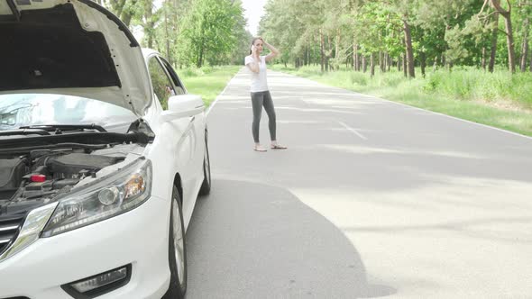 Female Driver Calling Tow Truck Service After Her Car Broke on Countryside Road