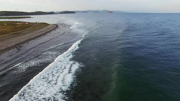 Drone View of Surfers Waiting for a Wave in the Sea at Sunset