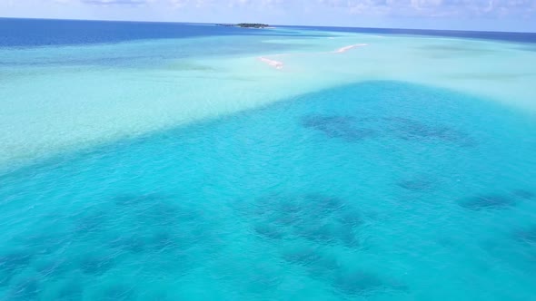 Aerial drone travel of island beach journey by blue lagoon with sand background