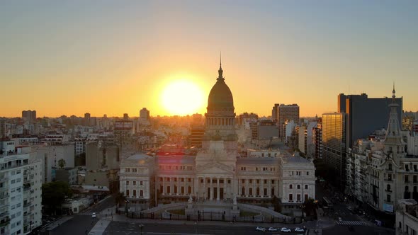 Aerial jib down over Monument of Two Corngresses in square near Argentine Congress building at golde