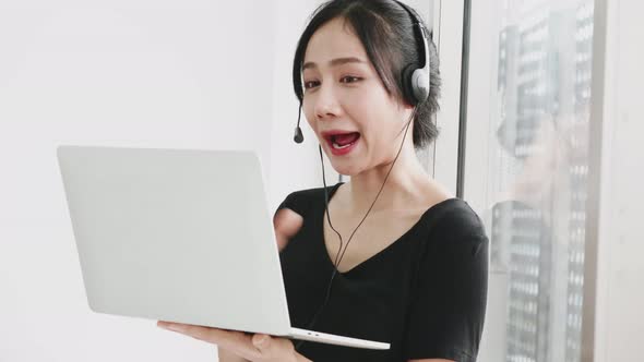 Happy business woman working by video conference with laptop from home.