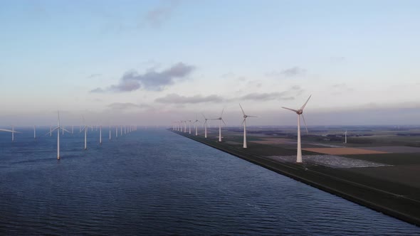 Offshore Windmill Park with Clouds and a Blue Sky Windmill Park in the Ocean Drone Aerial View with