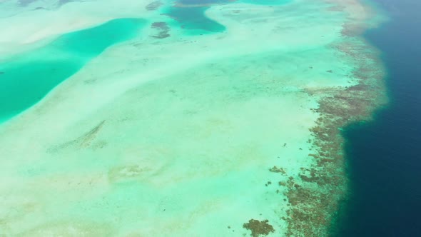 Aerial: flying over tropical island white beach caribbean sea turquoise water co