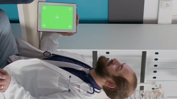 Vertical Video Pregnant Patient and Doctor Analyzing Greenscreen Display