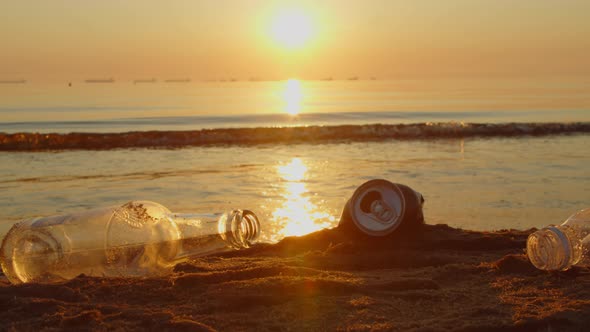 Volunteer Collects Plastic Garbage in a Bag on the Beach