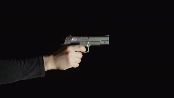 Human hand with a pistol show up in a frame alt