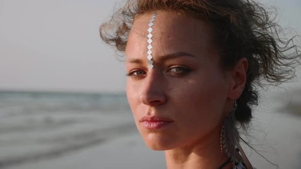 Portrait of Young Pretty Woman Looking on the Sea, and Then Turning To Camera