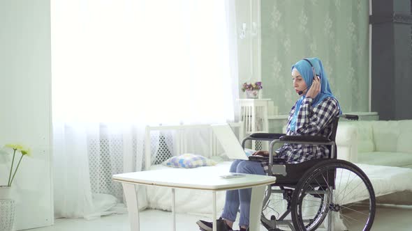 Beautiful Young Woman in Hijab Disabled Person Smiling Wheelchair Teleworking in the Internet