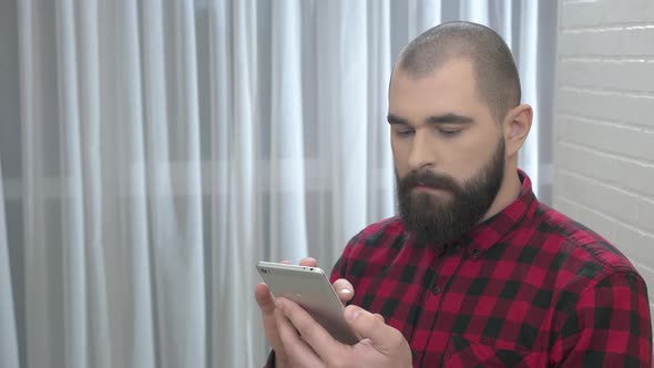 Bearded Man Using Mobile Phone
