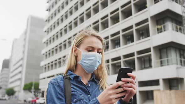 Low angle view of Caucasian woman wearing a mask