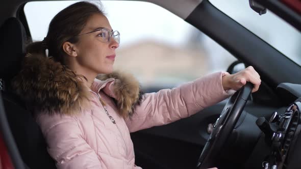 Portrait of a Girl with Glasses Who is Driving a Car She Turns Off the Car and Goes Out  Slow Mo