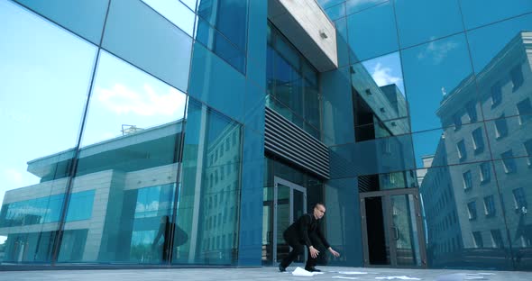 Young Clumsy Office Manager Lifting the Fallen Documents From Floor Near Modern Business Center