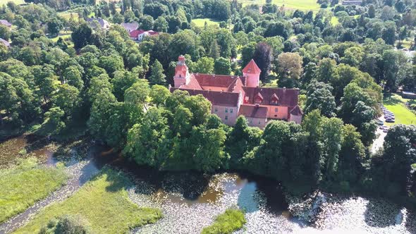 Edole Castle Manor and Old Village With Lake in Latvia, Aerial Shot From Above.