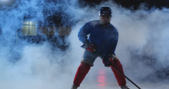 Male Hockey Player with a Puck on the Ice Arena Shows Dribbling Moving Directly Into the Camera and