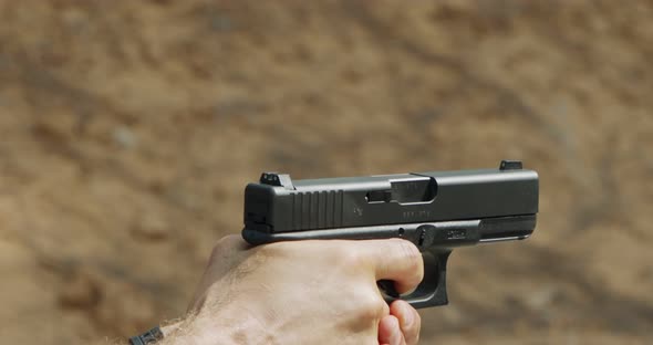 Pistol shooting bullets in slow motion footage. Hand guns in firing range