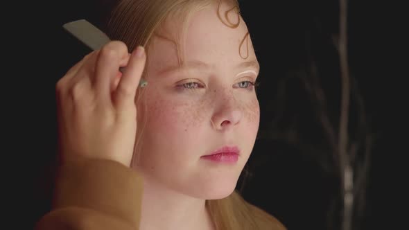 Cropped Shot of Woman Doing Hairstyle to Teenage Girl