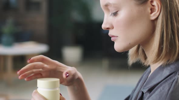 Young Woman Smelling Handmade Cream